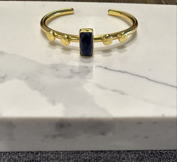 Sustainable Gold-plated lapis lazuli bracelet gemstone on a marble surface