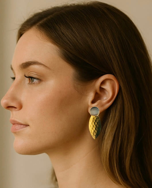 women’s side profile wearing handmade sustainable gold-plated gray gemstone bold earrings