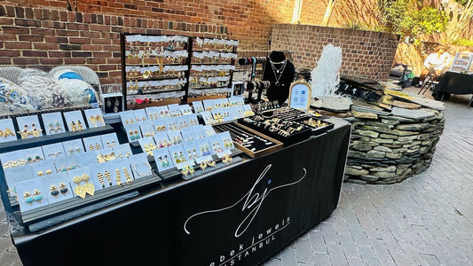 Bebek jewels table of handmade gold-plated jewelry at Georgetown’s Art All Night Market 