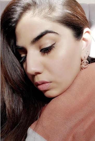 Model wearing artisanal gold plated Evil Eye earrings by Bebek Jewels