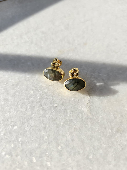 Dainty oval faceted labradorite studs are embellished on top with gold plated ball detailing