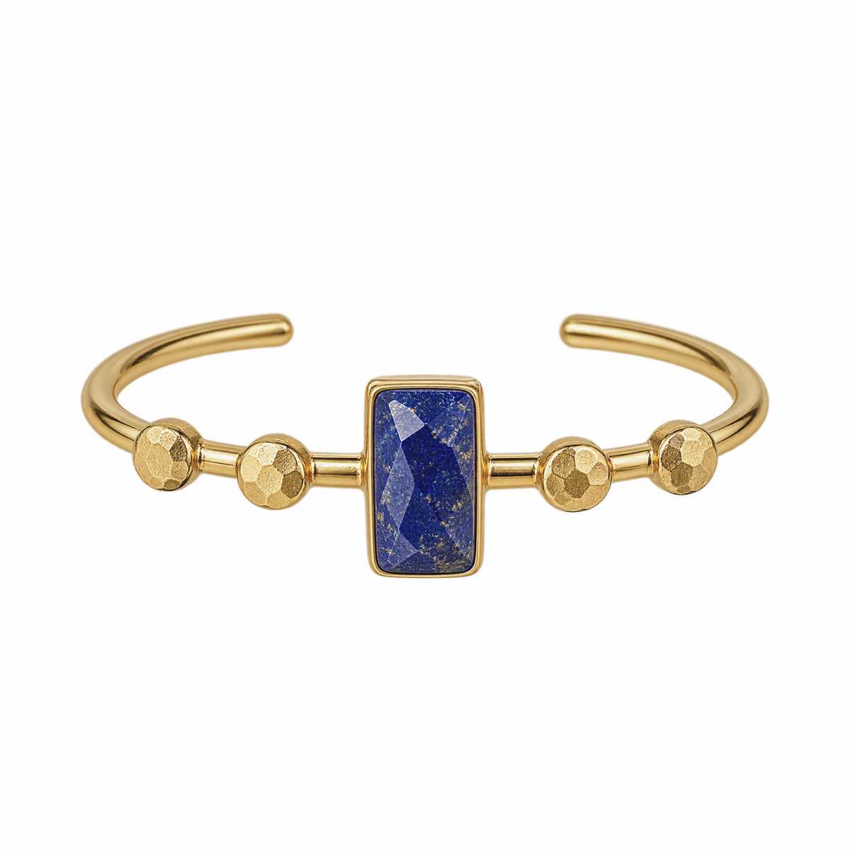 Gold cuff bracelet featuring a central rectangular blue lapis lazuli stone and three textured gold embellishings on each side, shown on a plain white background.