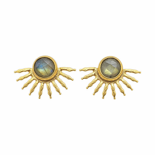 A pair of gold sunburst stud earrings with oval labradorite stones in the center, set against a plain white background.