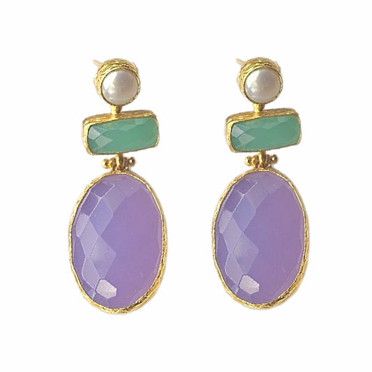 A pair of lilac quartz and aqua chalcedony dangle earrings with gold plating and pearl accents, displayed on a surface with a white background