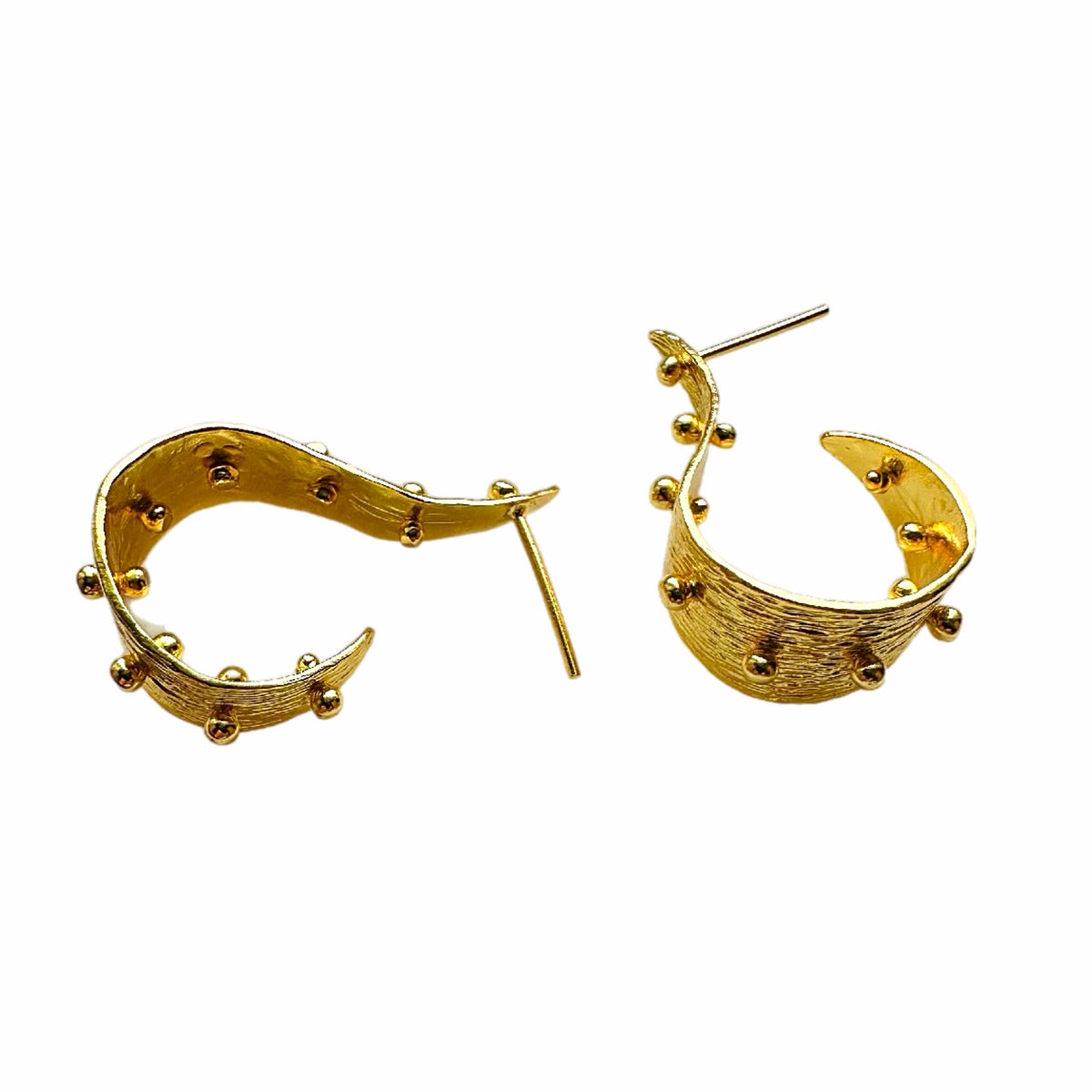 A pair of textured contemporary gold hoop earrings with small raised gold ball accents, on a white background.