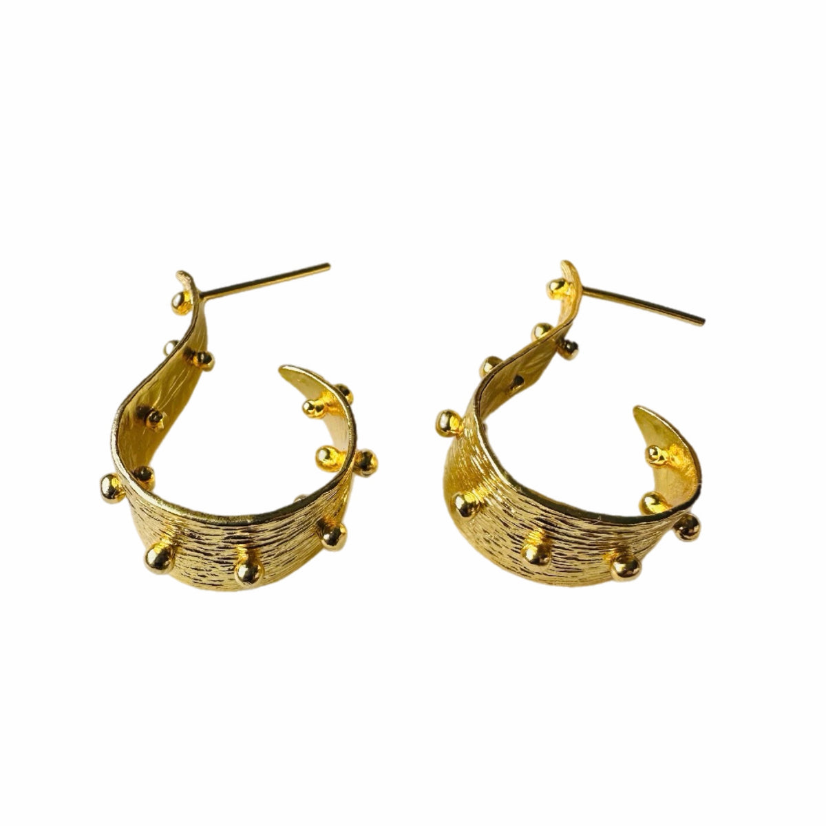 A pair of textured contemporary gold hoop earrings with small raised gold ball accents, placed on a plain white background.