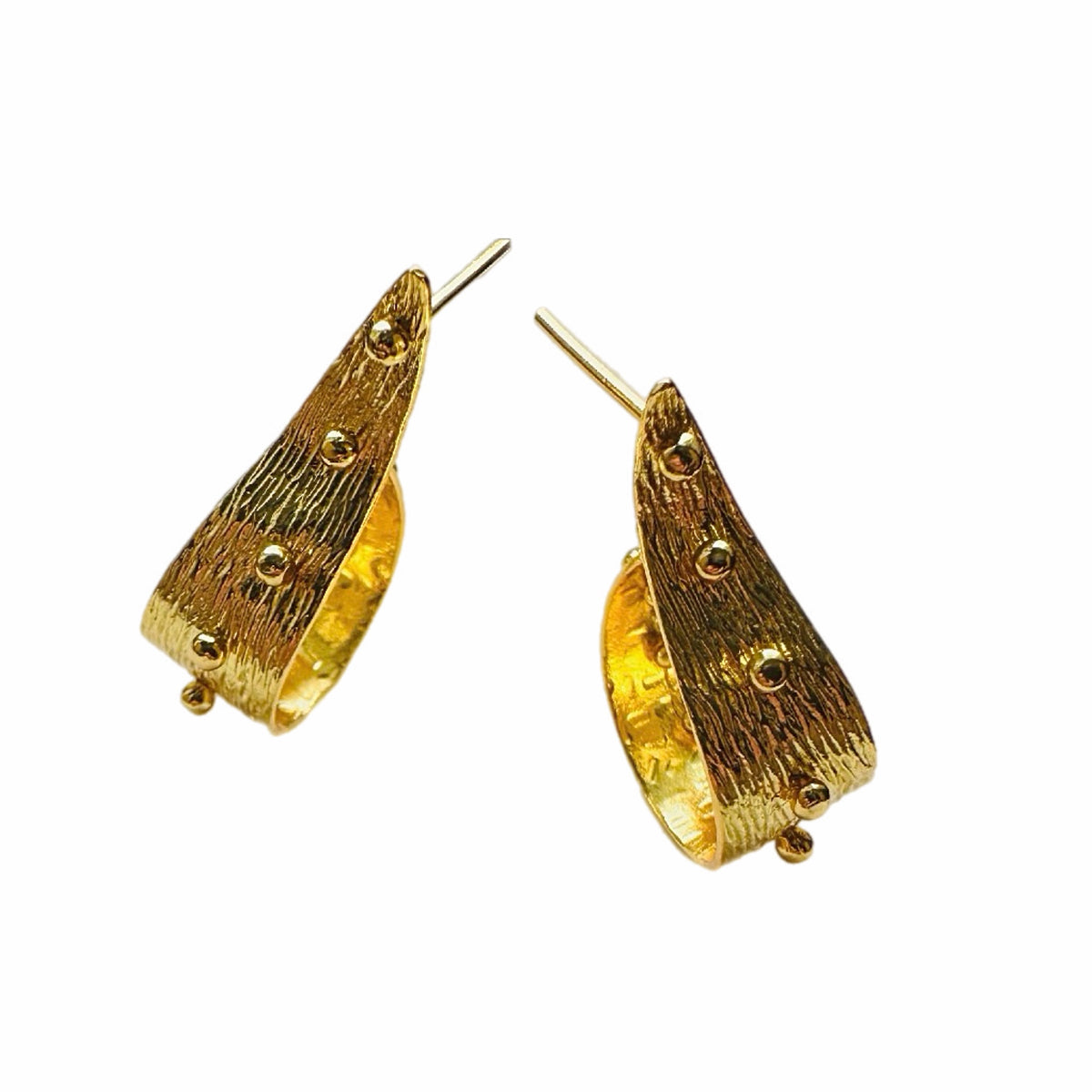 A pair of textured contemporary gold hoop earrings with small raised gold ball accents, arranged on a plain white background.
