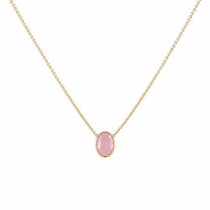A zoomed out image of minimal gold chain faceted rose quartz pendant necklace in a on a plain white background.