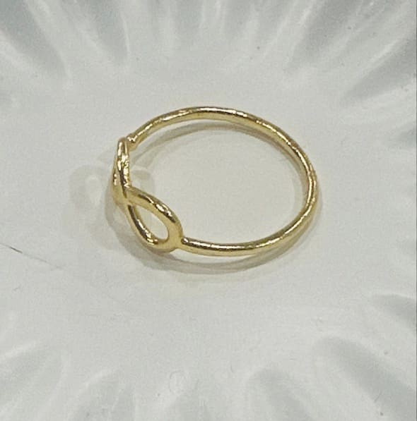 Adjustable eco-friendly waterproof gold-plated ring on a white background facing left 