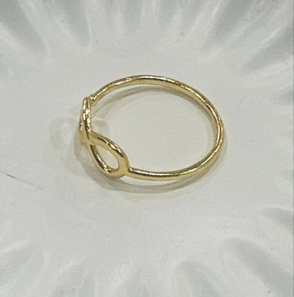 Adjustable eco-friendly waterproof gold-plated ring on a white background facing left 