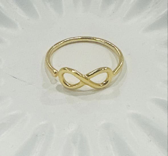 Adjustable Artisanal sustainable waterproof Gold-plated infinity ring on a white background