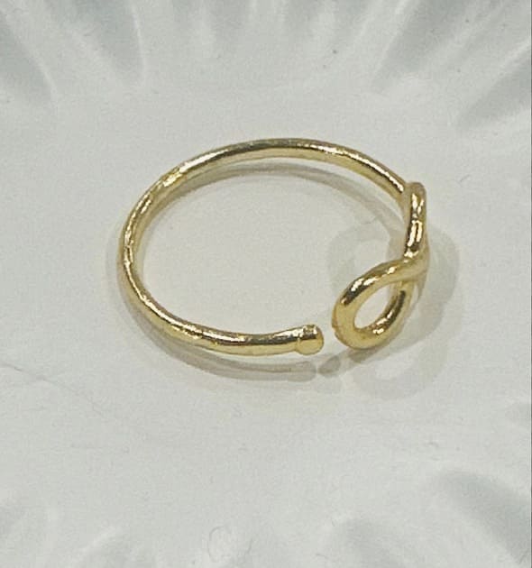 Adjustable eco-friendly waterproof Gold-plated infinity ring on a white background facing right 