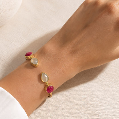 A-close-up-of-a-wrist-wearing-a-gold-plated-snow-quartz-and-ruby-adjustable-cuff-bracelet-by-Bebek-Jewels