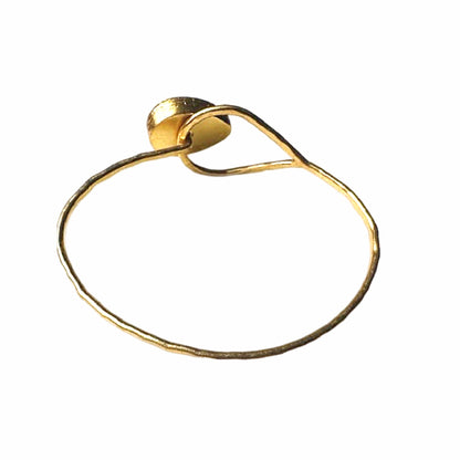 Artisanal Gold-plated hammer-finished bracelet with a red ruby gemstone on white