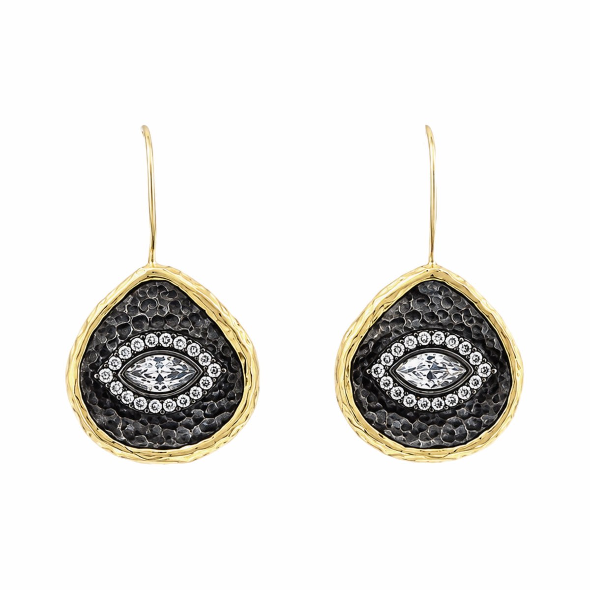 A pair of gold and dark silver teardrop-shaped drop earrings with a hammered gold finish, a textured center, and a central clear zircon evil  eye gemstone surrounded by small clear stones, on white background.