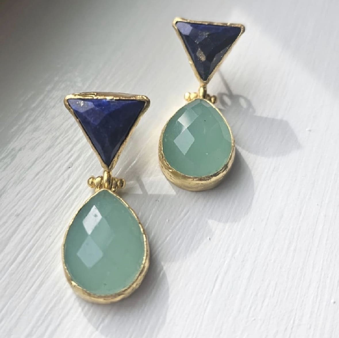 handmade sustainable gold-plated lapis lazuli and aqua chalcedony drop earrings on white windowsill 