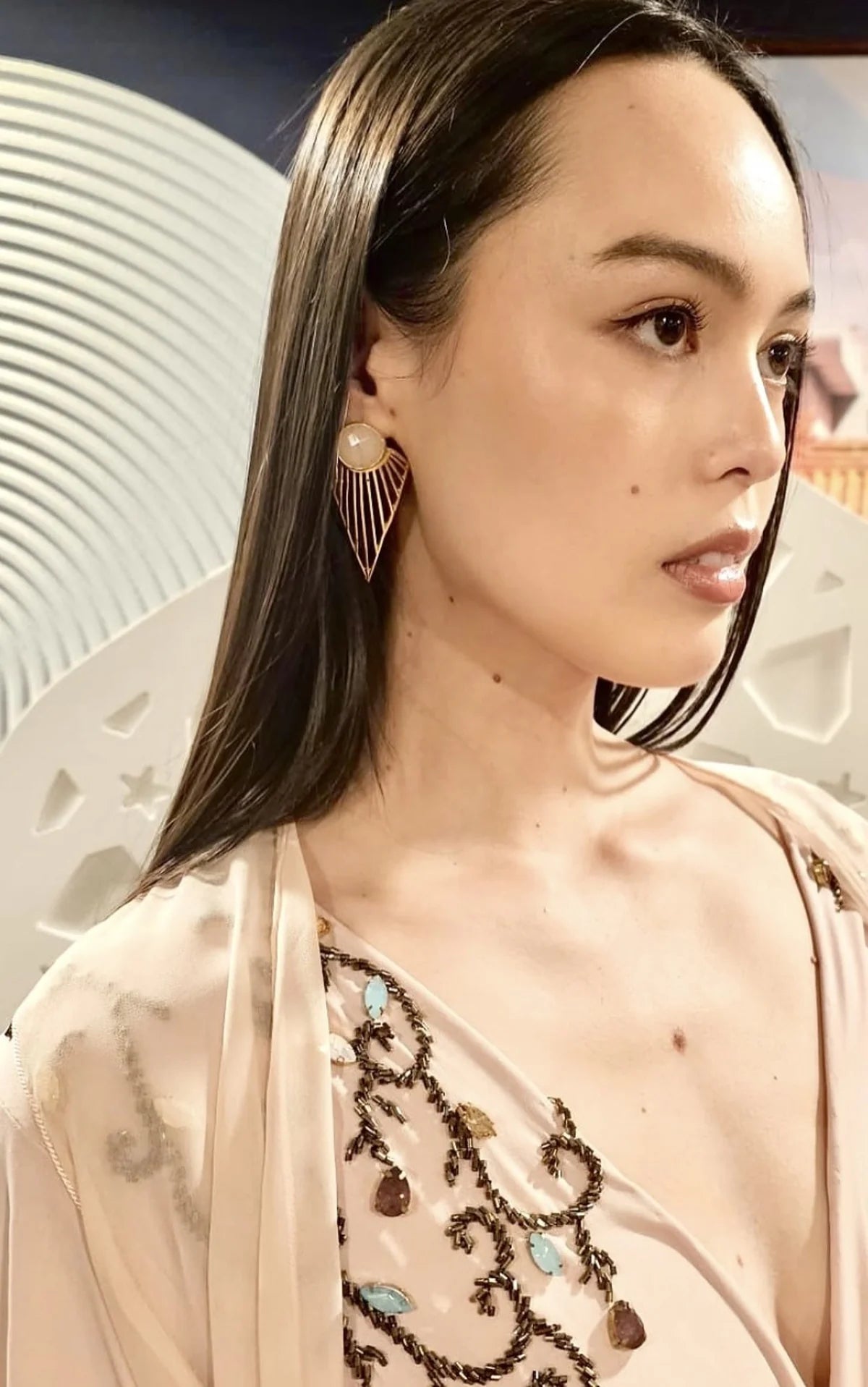 Asian model wearing long rose quartz and gold earrings by Bebek Jewels 