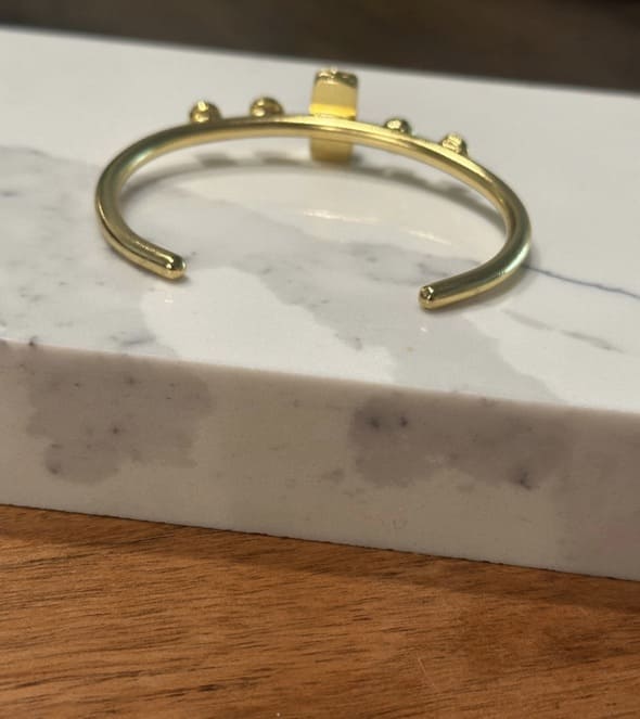 Back of sustainable Gold-plated Ruby bracelet on a marble surface