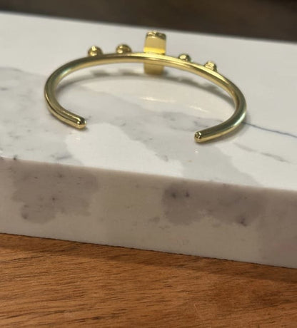 Back of artisanal eco-friendly Gold-plated bracelet on a marble surface