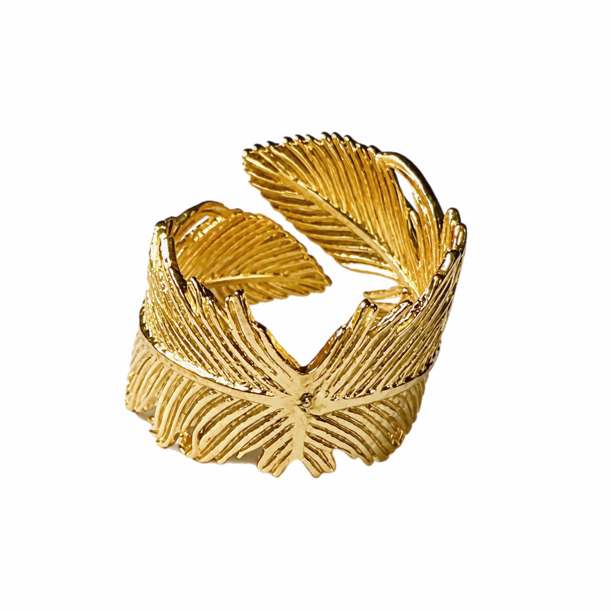 Back view of A gold-plated feather-shaped ring with textured, ribbed detailing, shown on a plain white background