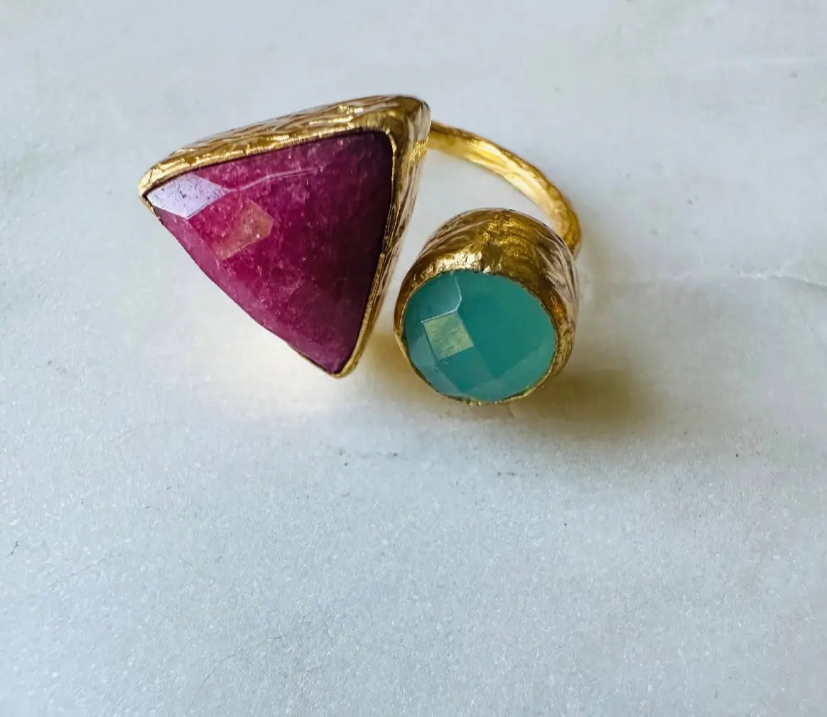 Gorgeous handmade sustainable Gold-plated gemstone ring with a ruby triangular gem and aqua chalcedony round gem on a light background