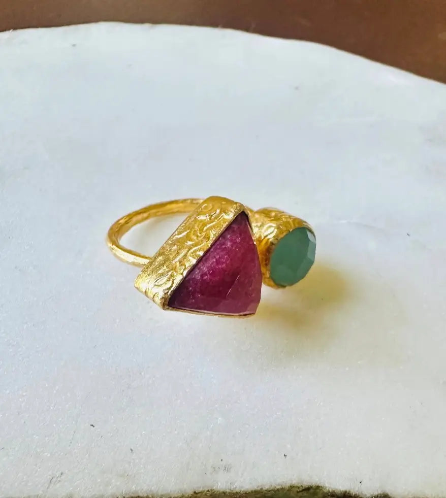Handmade gold-plated sustainable gemstone ring with triangular ruby and round aqua chalcedony facing right against white background 