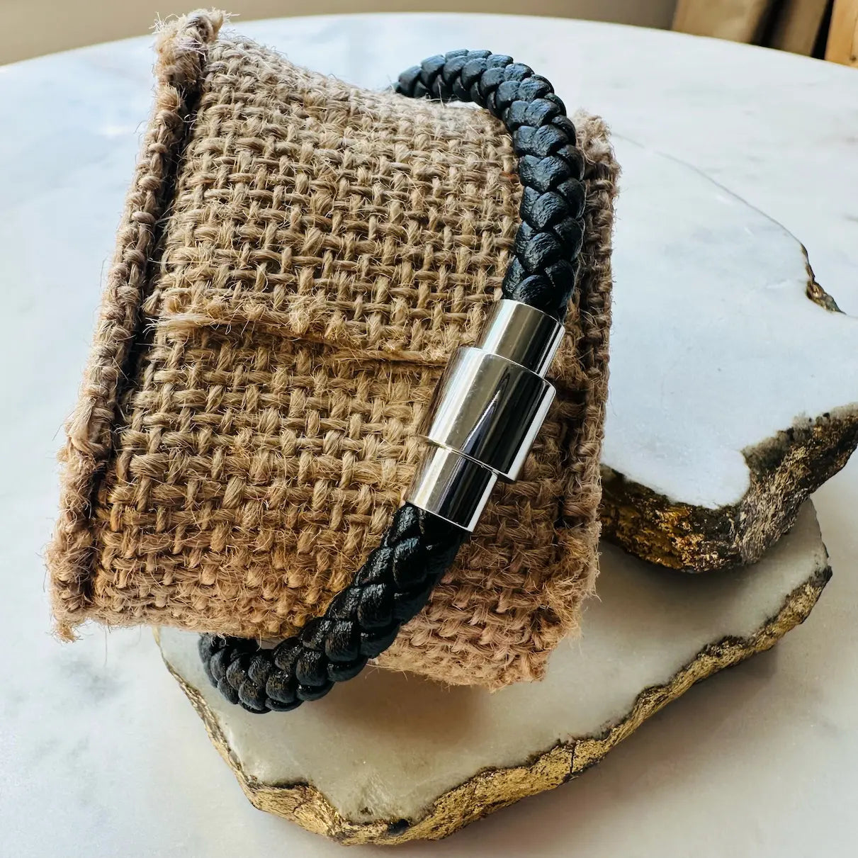 Back of handmade black woven Bracelet with braided cord silver metal clasp