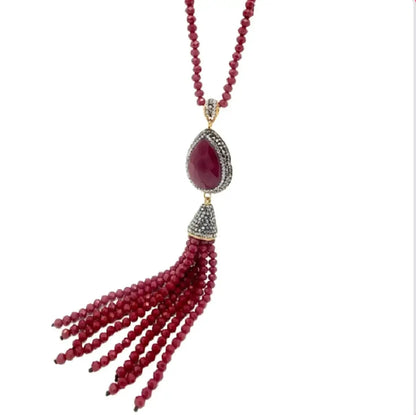 Close-up of elegant Artisanal Turkish Long Red beaded tassel necklace with a teardrop-shaped pendant on a white background