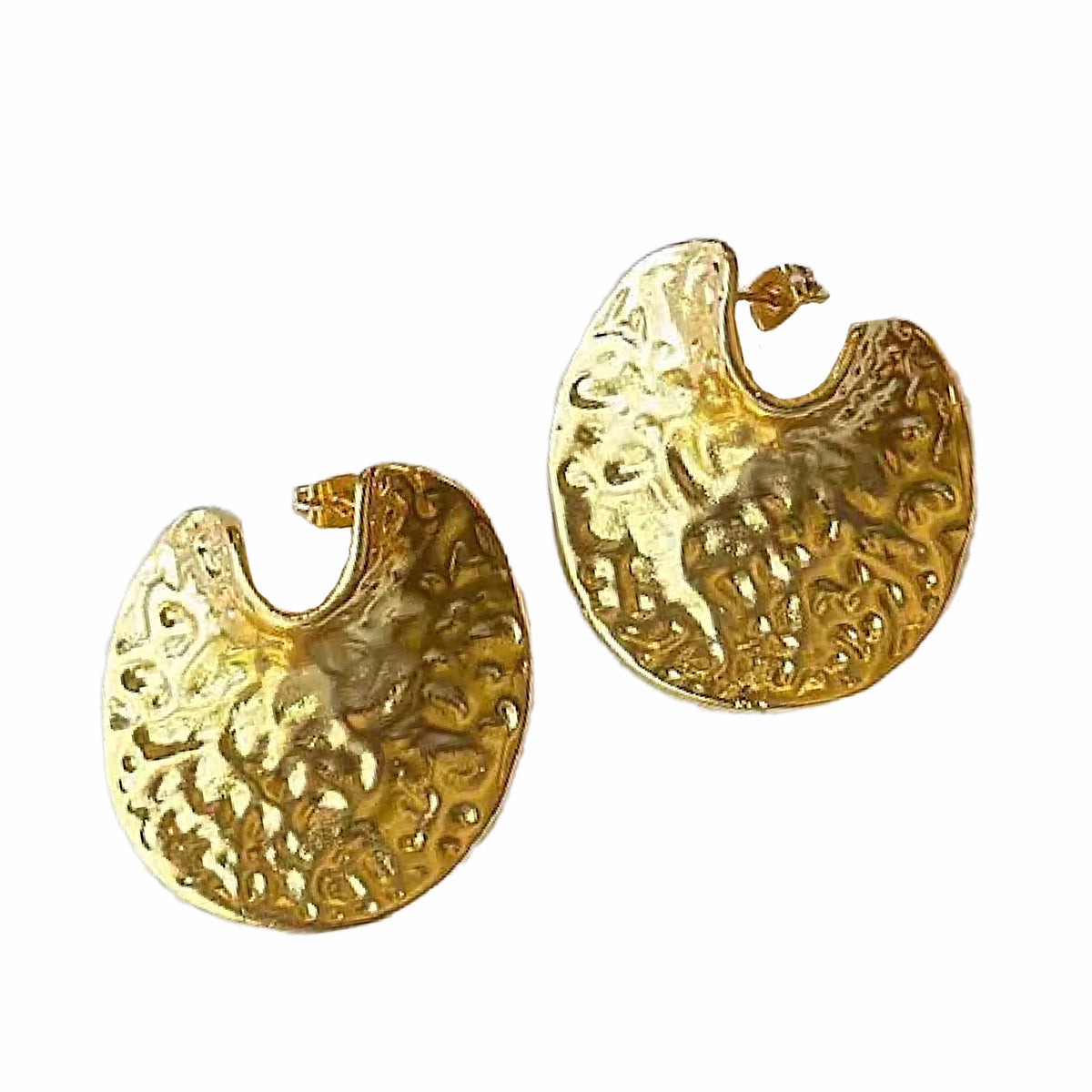 A pair of textured gold crescent-shaped contemporary hoop earrings on a plain white background.