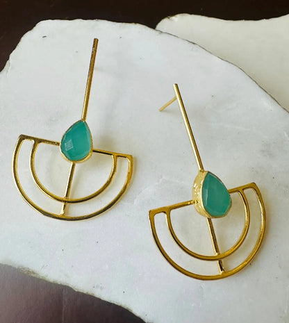Gold-plated handmade sustainable Aqua Chalcedony earrings with green teardrop stones on a white stone