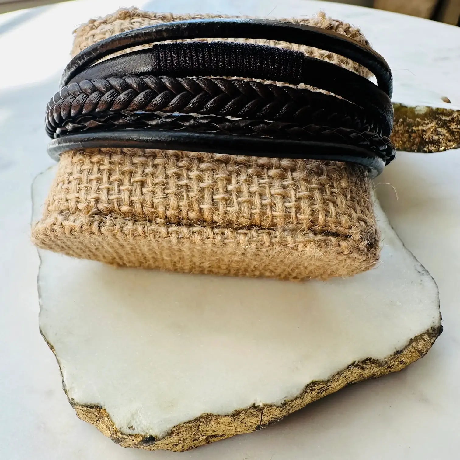 Men’s Handmade bohemian edgy Brown braided Stack cuff bracelet on a textured surface