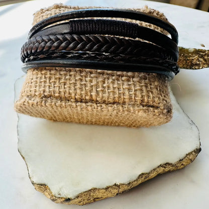 Men’s Handmade bohemian edgy Brown braided Stack cuff bracelet on a textured surface