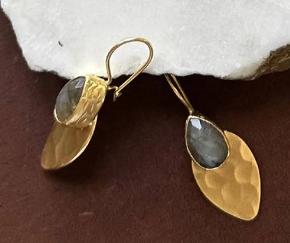 High quality artisanal Gold-plated hammer-finished earrings with gray labradorite gemstones on a dark surface