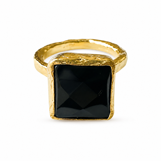 Close up of Artisanal sustainable gold plated square onyx ring on white