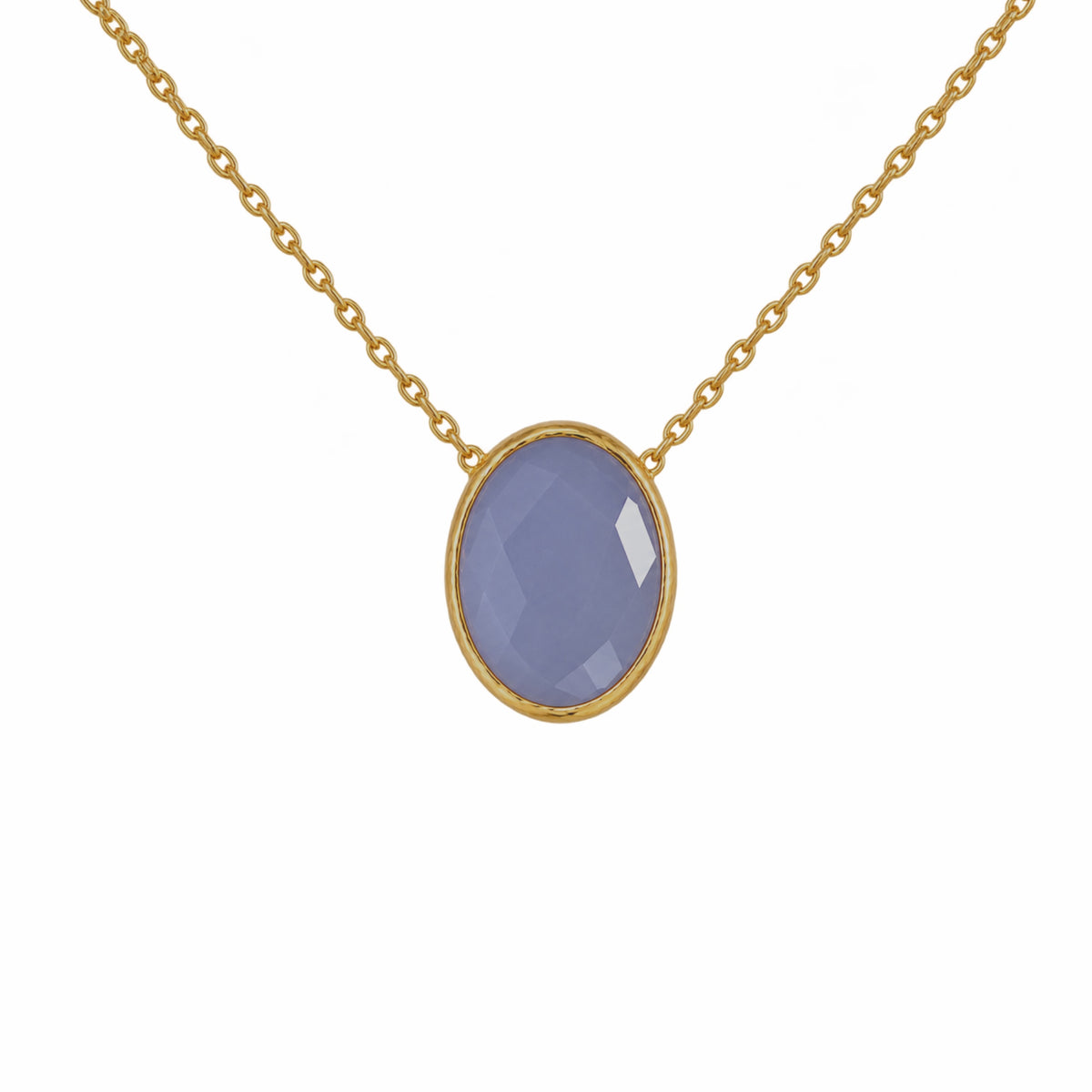 Close up of minimal gold chain faceted blue quartz pendant necklace on white background