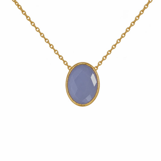 Close up of minimal gold chain faceted blue quartz pendant necklace on white background