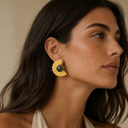 Close up of model wearing beige halter top and gold plated labradorite disc earrings