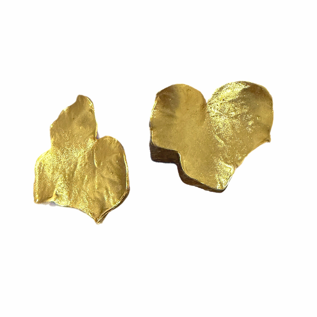 Contemporary handmade bold gold plated leaf stud earrings on white background With shadows 