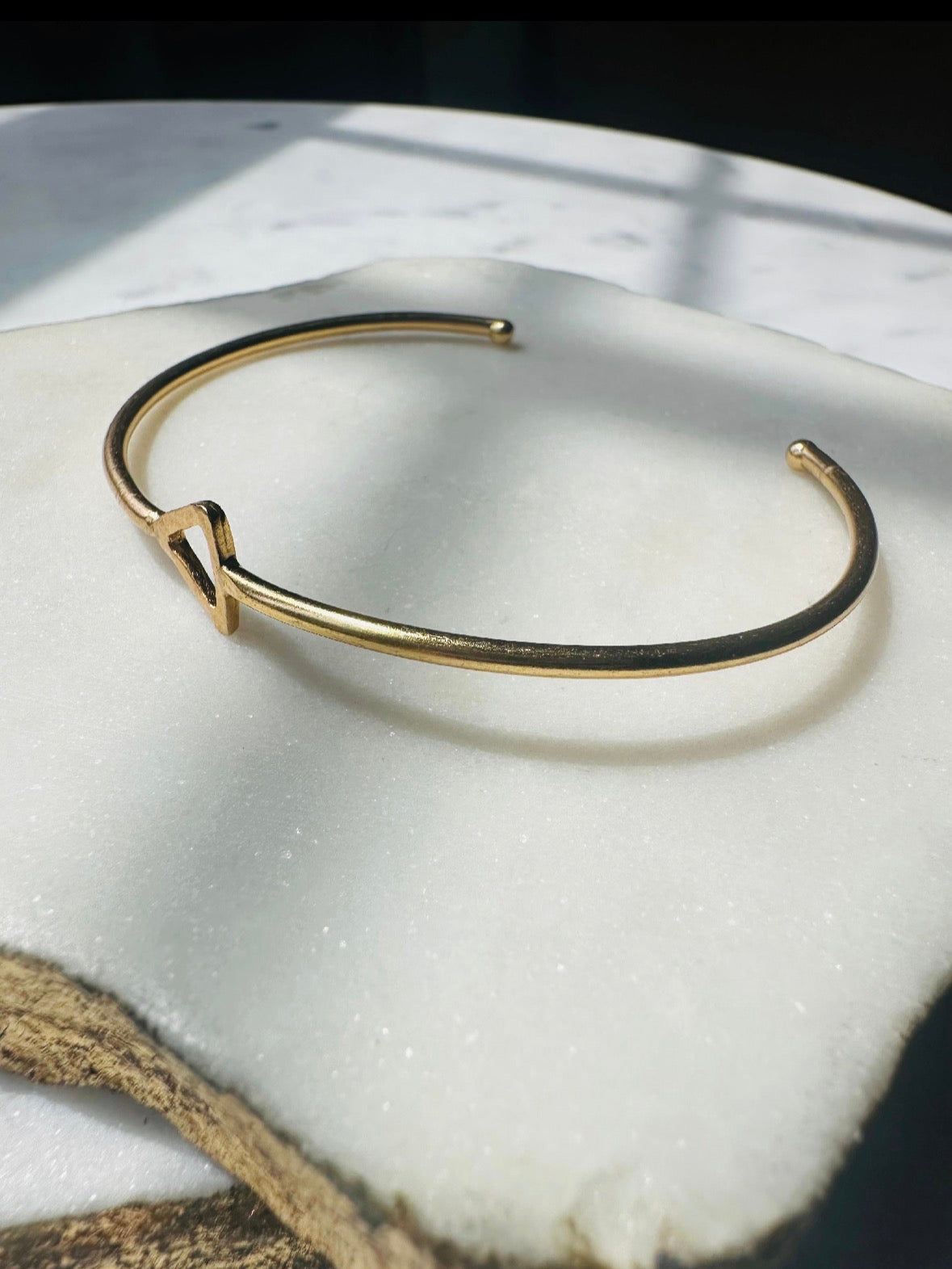 Sustainable Gold-plated dainty bracelet on a marble surface