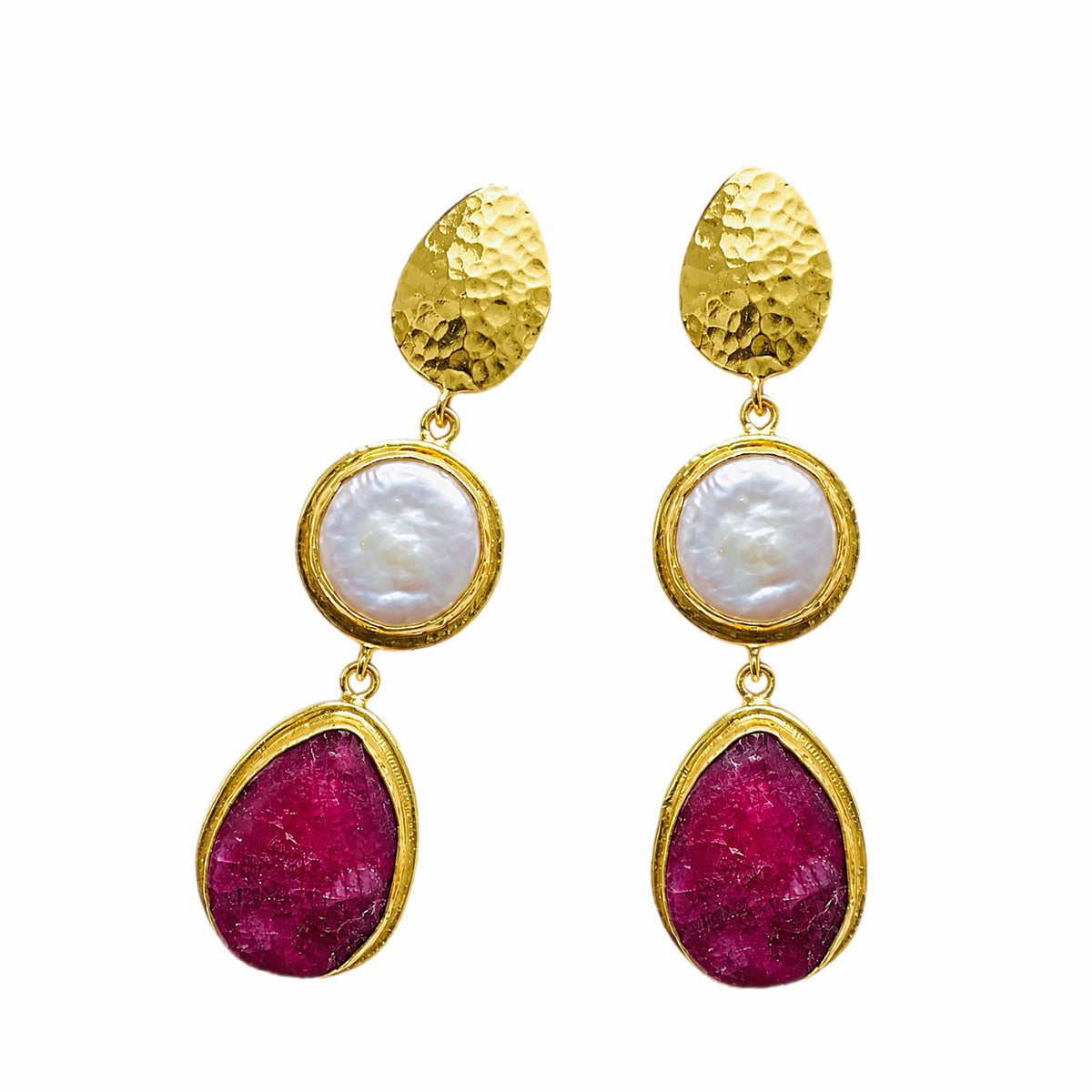 Elegant handmade gold-plated ruby and flat pearl dangle earrings on white surface 