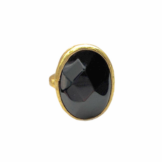 Front view of A textured handmade gold ring featuring a large, faceted onyx gemstone ring against a plain white background