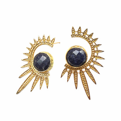 Gold sun-shaped earrings with blue lapis lazuli gemstones on white background