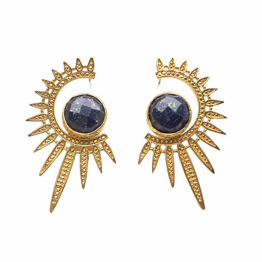 Gold sun-shaped earrings with blue lapis lazuli gemstones on a white background