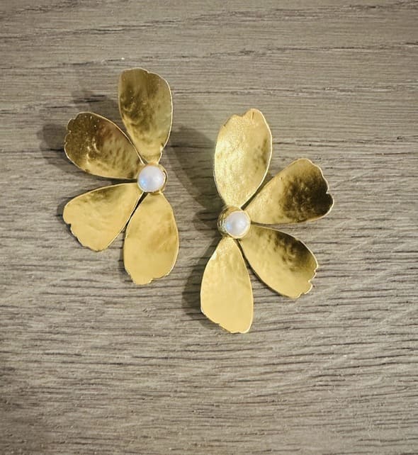 Artisanal sustainable gold-plated pearl bold flower earrings against wooden background 