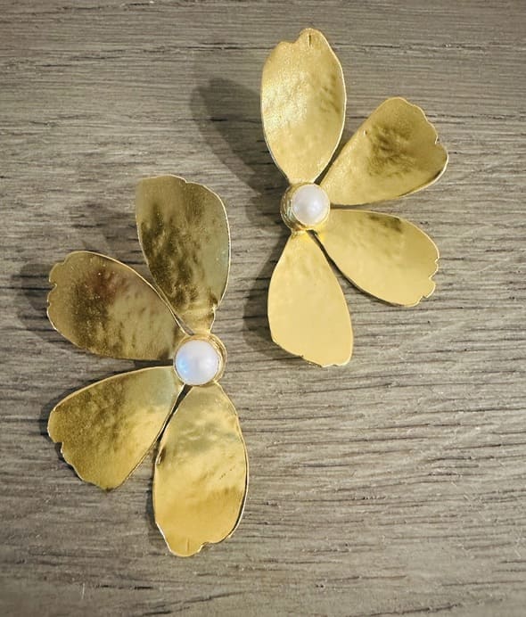 Handmade sustainable bold Gold-plated contemporary pearl flower-shaped earrings on a wooden surface