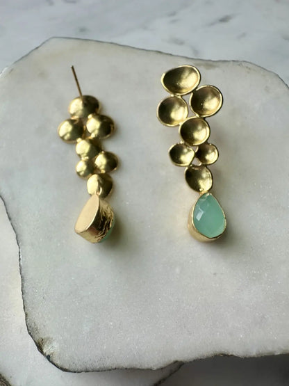 A pair of artisanal Turkish gold-played Aqua chalcedony drop earrings, with one backwards in white marble 