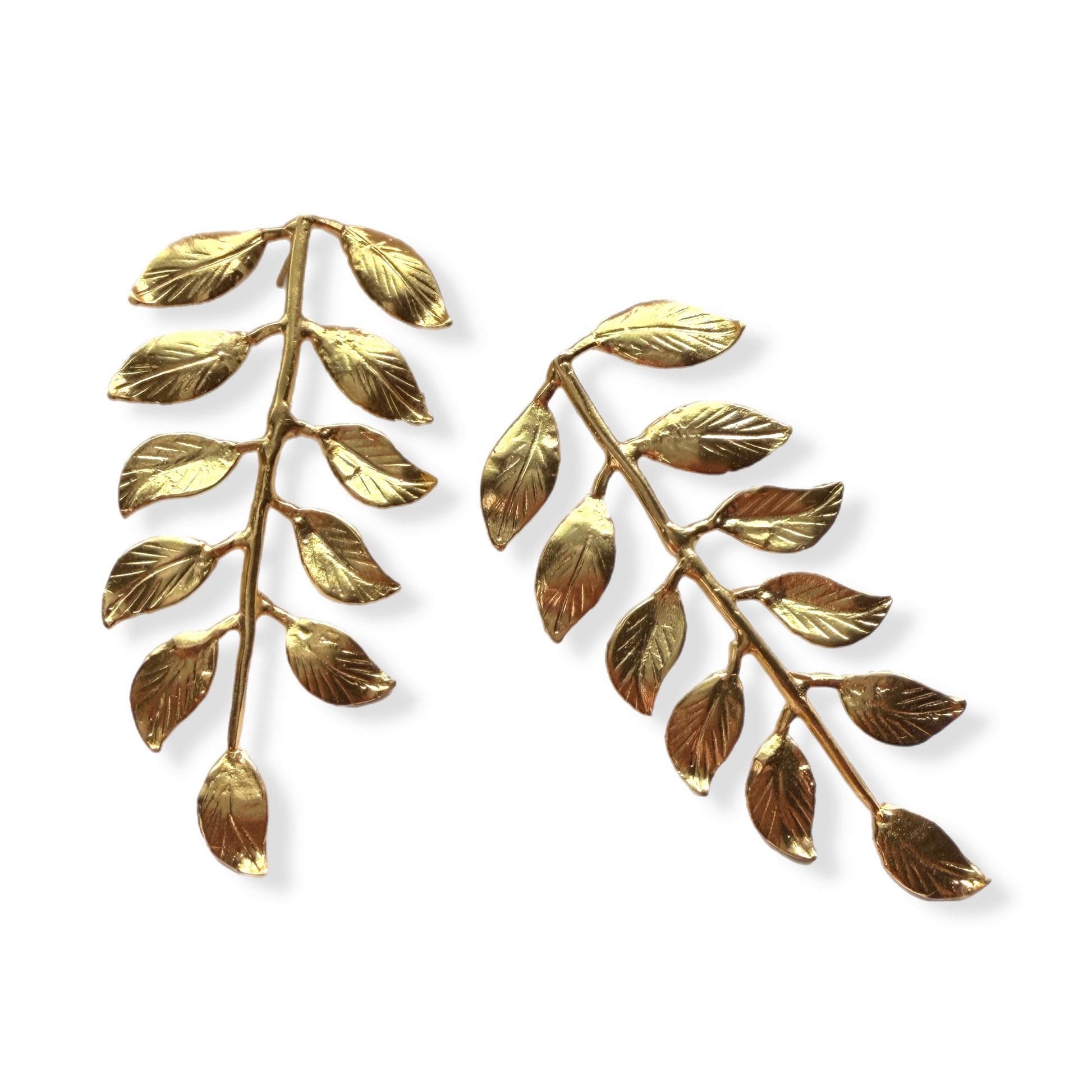 Artisanal eco-friendly Gold-plated leaf earrings on a white area