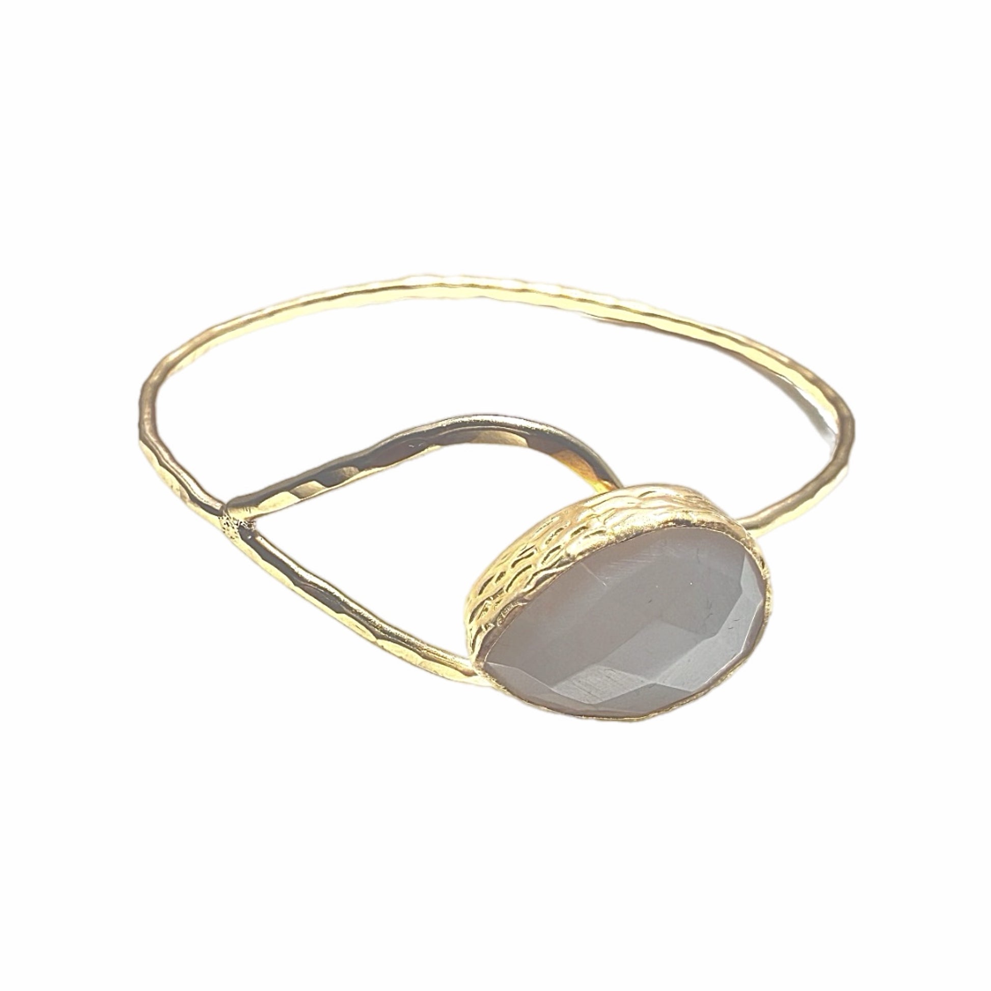 Gold-plated snow Quartz teardrop bracelet with a stone on a white background 
