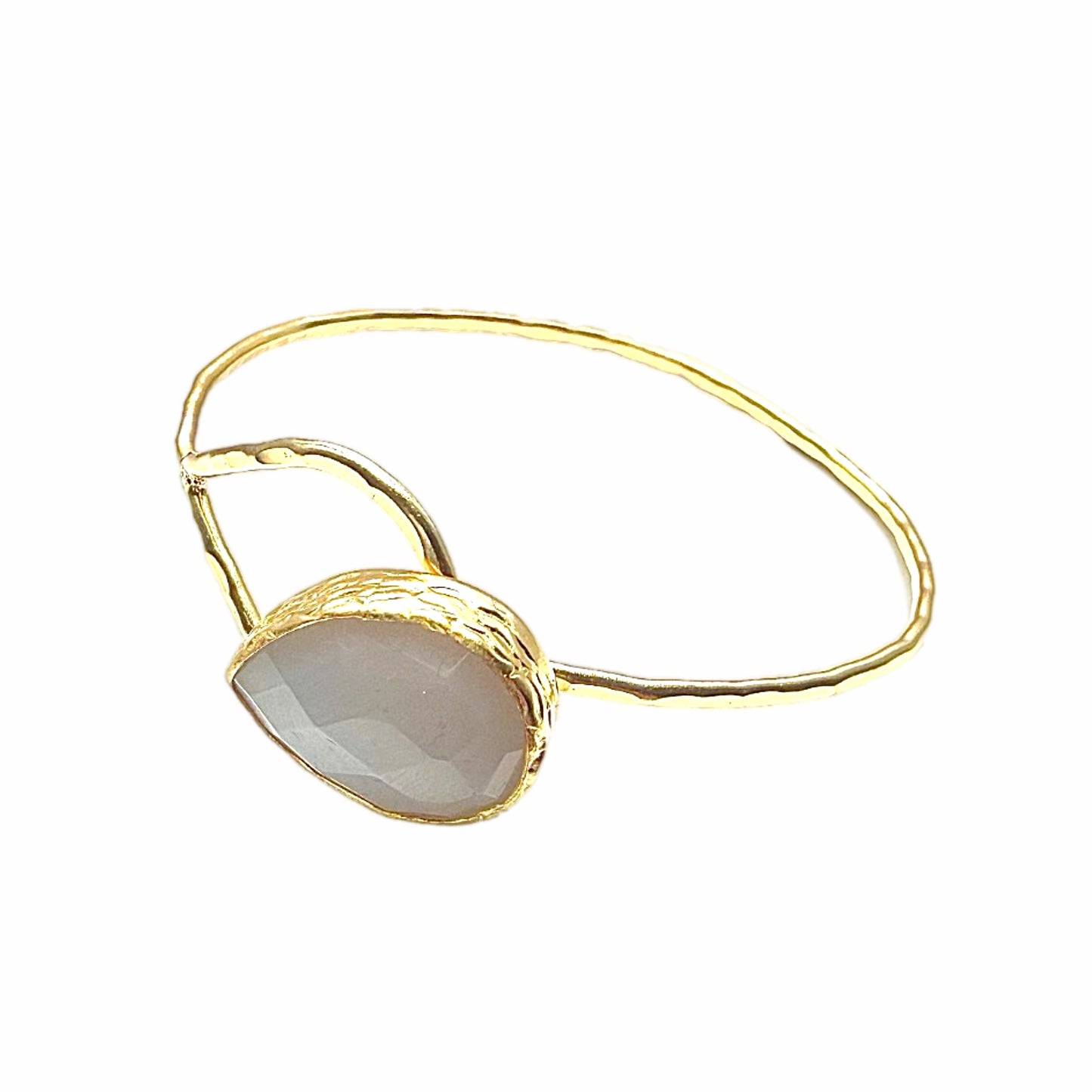 Gold-plated snow Quartz teardrop bracelet with a stone on a white background Facing left