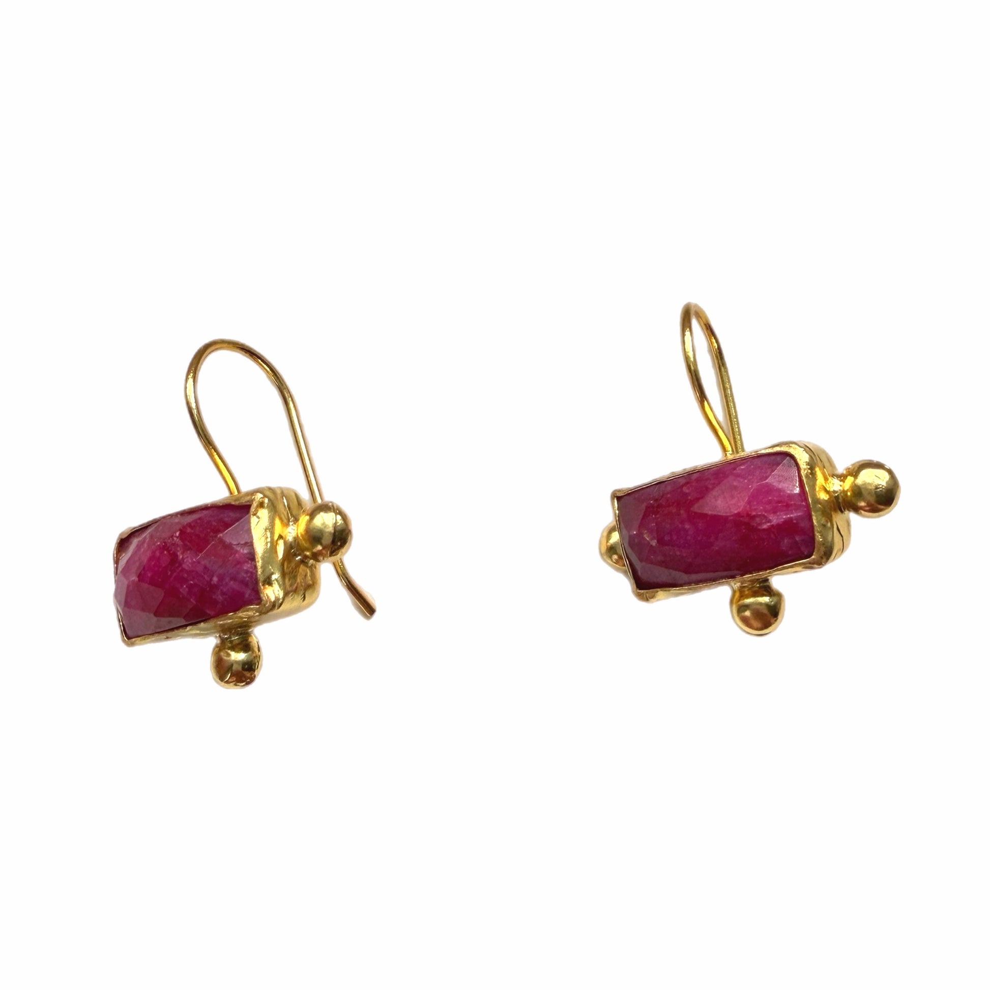 A pair of gold drop earrings featuring rectangular faceted pinkish-red gemstones, set in gold with small gold beads and hooks, shown on a plain white background.